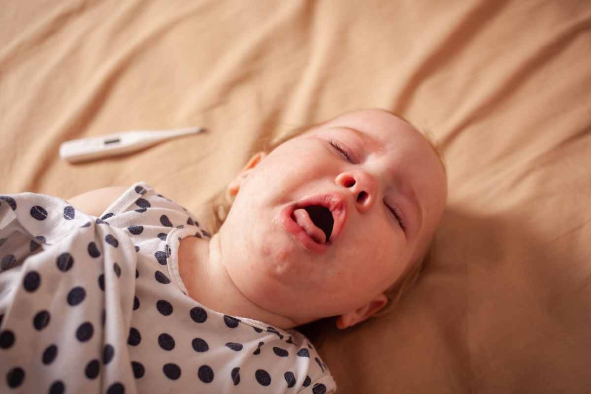 A sick baby with croup has a fever and is crying and coughing loudly in Austin, Texas.
